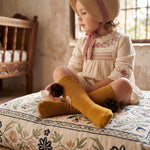 Girl Mustard High Socks with Borlones — view 2 — handcrafted in Spain — AGÜ Baby