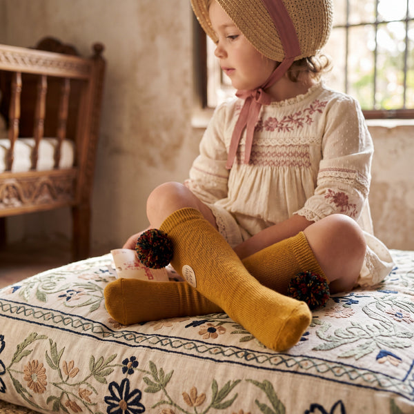 Girl Mustard High Socks with Borlones — view 2 — handcrafted in Spain — AGÜ Baby